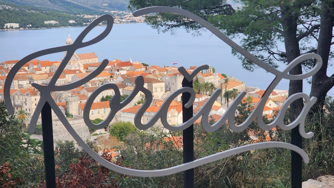 Panoramablick auf die Altstadt von Korčula mit Stadtmauer und Meer